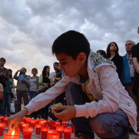 A Crimean Tatar boy lights a candle during a memorial ceremony in Kiev on May 17, 2014, held on the 70th anniversary of the deportation of Tatars from Crimea. (SERGEI SUPINSKY/AFP/Getty Images)