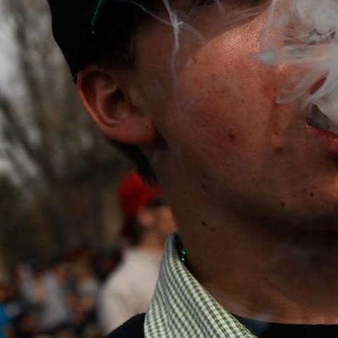 A student smokes a marijuana cigarette during a 'smoke out' with thousands of others April 20, 2010 at the University of Colorado in Boulder, Colorado. (Chris Hondros/Getty Images)