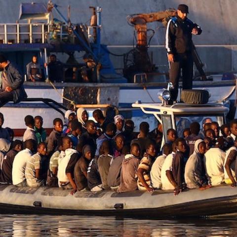 Sub-Saharan African migrants are rescued by the Libyan coastguard after their inflatable boat started to sink off the coastal town of Guarabouli, November 20, 2014. There were 108 people rescued from the sinking raft. (MAHMUD TURKIA/AFP/Getty Images)
