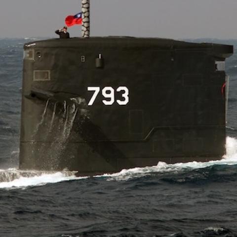 A navy soldier salutes from the Dutch-made Sea Dragon submarine during a combat skills demonstration in the watersnear the Tsoying navy base in southern Kaohsiung on January 14, 2014. (SAM YEH/AFP/Getty Images)