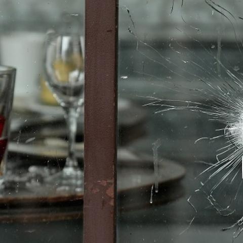 Bullets holes are seen through the glass door of a cafe near Casa Nostra after the terror attack on November 14, 2015 in Paris, France. (Christopher Furlong/Getty Images)