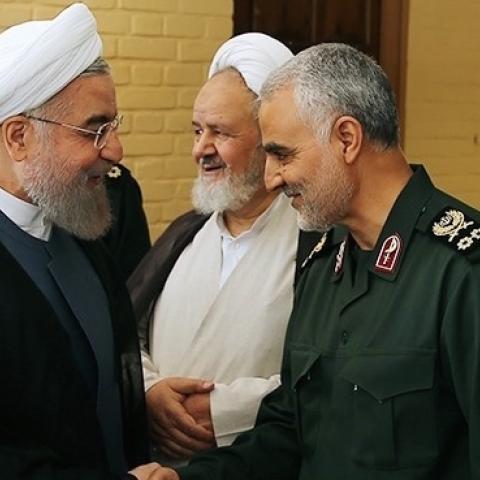Iranian President Hassan Rouhani (L-2) shakes hands with Iranian Quds Force commander Qassem Soleimani (R-2) in Tehran, Iran on September 15, 2015. (Pool/Iranian Presidency Press Office/Anadolu Agency/Getty Images)
