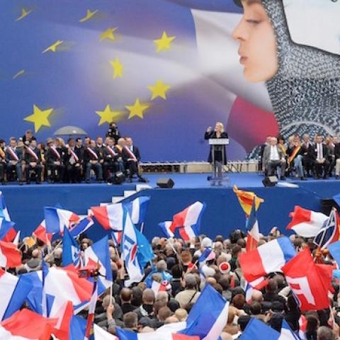 France's far-right National Front (FN) supporters watch leader Marine Le Pen (rear C) deliver a speech during a May Day rally in Paris on May 1, 2014. (PIERRE ANDRIEU/AFP/Getty Images)