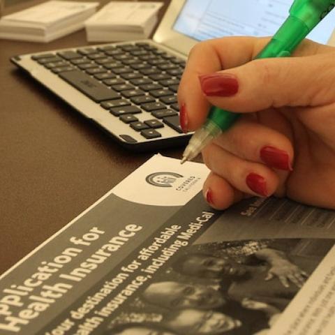 A healthcare reform specialist helps people select insurance plans at the free Affordable Care Act (ACA) Enrollment Fair at Pasadena City College on November 19, 2013 in Pasadena, California. (David McNew/Getty Images)