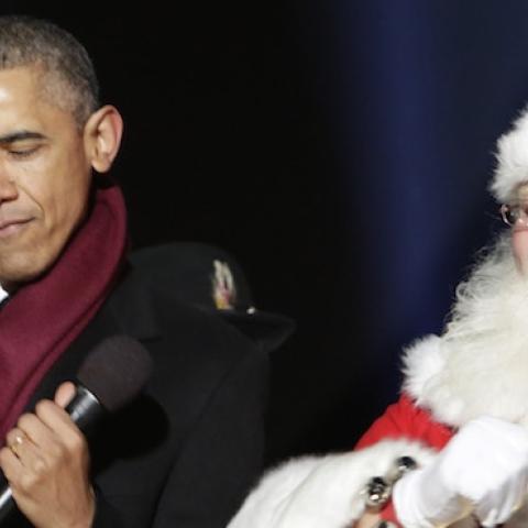 U.S. President Barack Obama dances with Santa Claus during the lighting of the National Christmas tree on December 4, 2014 in Washington, DC. The tree lighting ceremony marks a month-long series of holiday events in President's Park at The White House. (P