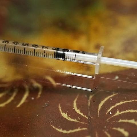 A syringe used for intravenous drug use lies on a table in a room on February 6, 2014 in St. Johnsbury, Vermont. (Spencer Platt/Getty Images)