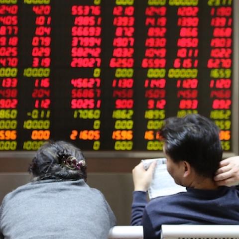 Investors observe stock market at an exchange hall on January 6, 2016 in Beijing, China. (ChinaFotoPress/Getty Images)