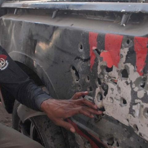 A police officer inspects a vehicle after a bomb went off near Gulbahar Police Station in Peshawar, Pakistan, April 24, 2015. Tehreek-e-Taliban Pakistan (TTP) have claimed responsibility for the attack. (Asianet-Pakistan / Barcroft Indi via Getty Images)