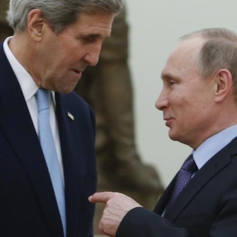 Russian President Vladimir Putin (R) speaks with US Secretary of State John Kerry during a meeting at the Kremlin in Moscow on December 15, 2015. (SERGEI KARPUKHIN/AFP/Getty Images)