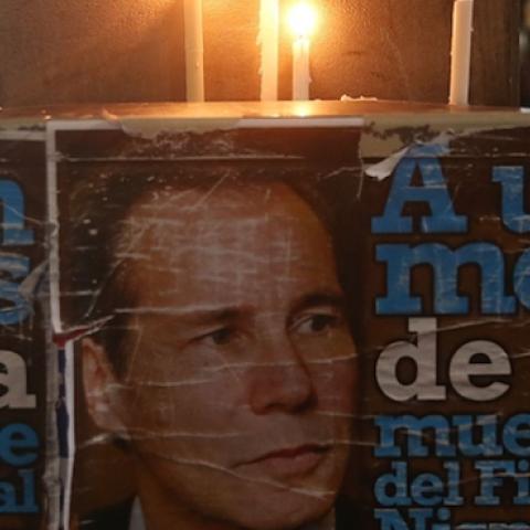 Candles burn above a poster of Albert Nisman following a 'Silent March' on February 18, 2015 in Buenos Aires, Argentina. (Mario Tama/Getty Images)