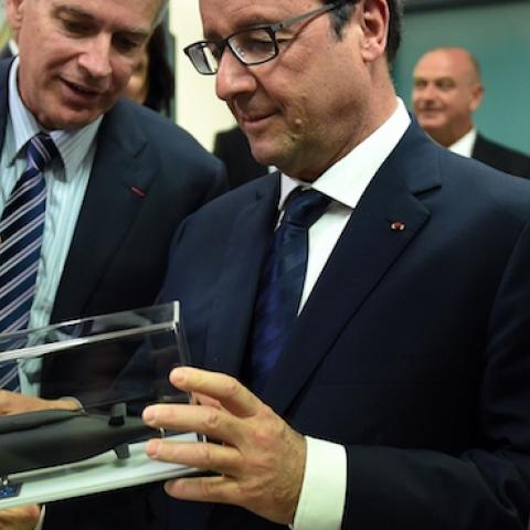 French President Francois Hollande, center, inspects a model of the Royal Australian Navy's Collins class submarine during a visit to French defense contractor Thales' office in Sydney on Nov. 18, 2014. (Dan Himbrechts - Pool/Getty Images)