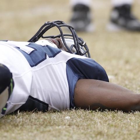 Marcus Trufant of the Seattle Seahawks lays on the ground after suffering a concussion against the Chicago Bears during the NFC Divisional playoff game at Soldier Field on January 16, 2011 in Chicago, Illinois. (Joe Robbins/Getty Images)