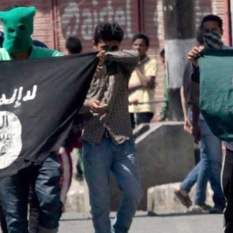 Kashmiri protesters displaying the flags of ISIS and Pakistan on June 27, 2015 in Srinagar, India. (Waseem Andrabi/Hindustan Times via Getty Images)