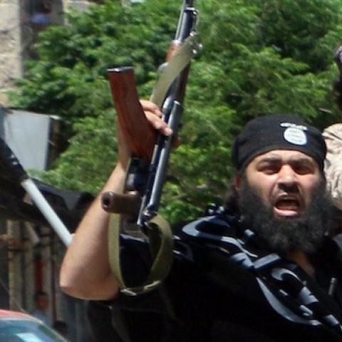 Fighters from Al-Qaeda's Syrian affiliate Al-Nusra Front drive in the northern Syrian city of Aleppo flying Islamist flags as they head to a frontline, on May 26, 2015. (Fadi al-Halabi/AFP/Getty Images)