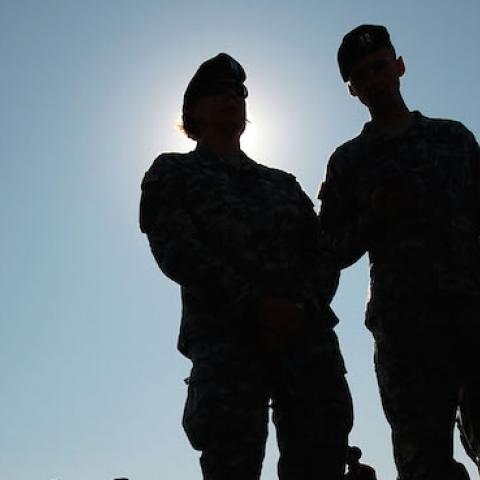 Soldiers in the 1st Infantry Division wait outside at a deployment ceremony as more soldiers at Fort Riley prepare to leave for another tour in Iraq August 13, 2009 at Fort Riley, Kansas. (Chris Hondros/Getty Images)
