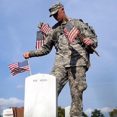 Members of the 3rd U.S. Infantry Regiment place American flags at the graves of U.S. soldiers buried in Section 60 at Arlington National Cemetery in preparation for Memorial Day May 24, 2012 in Arlington, Virginia. (Win McNamee/Getty Images)