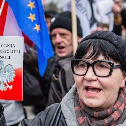 People hold the Polish constitution as they attend the anti-government demonstration against the refusal of polish government to accept verdict of Constitutional Court in Warsaw, March 10, 2016. (WOJTEK RADWANSKI/AFP/Getty Images)