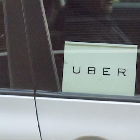Man driving a sedan with Uber sticker on it, New York City, October 17, 2015. (Roberto Machado Noa/LightRocket via Getty Images)