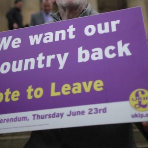 A Vote to Leave campaigner holds a placard as Nigel Farage campaigns for votes to leave the European Union in the referendum on May 25, 2016 in Bolton, England. (Christopher Furlong/Getty Images)