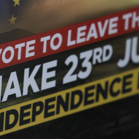 A Leave campaigner holds placards in Clacton-on-Sea, eastern England on June 21, 2016. (JUSTIN TALLIS/AFP/Getty Images)
