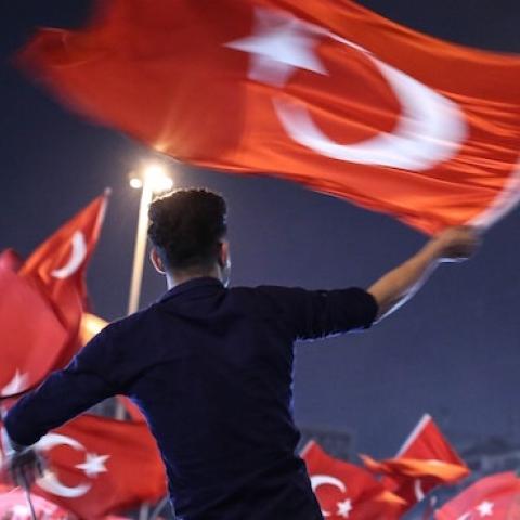 People carry Turkish flags at Taksim Square in Istanbul, Turkey on July 17, 2016 as they gather to protest the failed military coup attempt. ( Onur Coban/Anadolu Agency/Getty Images)
