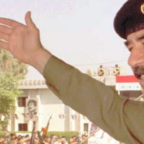  Iraqi President Saddam Hussein waves to his supporters in his first public appearance in Baghdad October 18, 1995. (INA/AFP/Getty Images)