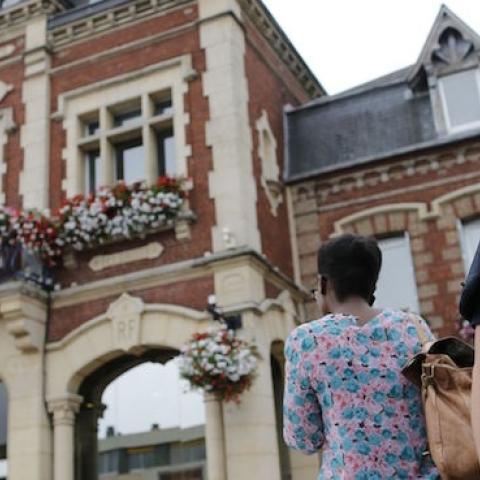 A French police officer stands guard by Saint-Etienne-du-Rouvray's city hall following a hostage-taking at a church in Saint-Etienne-du-Rouvray, northern France, on July 26, 2016 that left the priest dead. (CHARLY TRIBALLEAU/AFP/Getty Images)