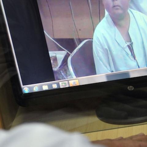 French Hospital Institute for Children doctor talks face to face with a patient from Kabul, on May 13, 2012 (Photo: BAY ISMOYO/AFP/Getty Images)