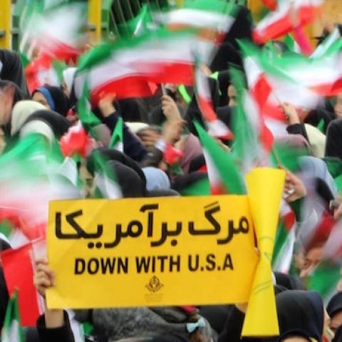 Iranian schoolgirls wave their national flag and hold an anti-US slogan during celebrations in Tehran's Azadi Square (Freedom Square) to mark the 37th anniversary of the Islamic revolution on February 11, 2016. (ATTA KENARE/AFP/Getty Images)