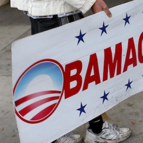 Pedro Rojas holds a sign directing people to an insurance company where they can sign up for the Affordable Care Act before the February 15th deadline on February 5, 2015 in Miami, Florida. (Joe Raedle/Getty Images)