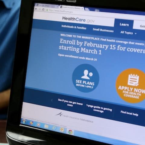 Hisham Uadadeh enrolls in a health insurance plan under the Affordable Care Act with the help of A. Michael Khoury at Leading Insurance Agency on February 13, 2014 in Miami, Florida. (Joe Raedle/Getty Images)