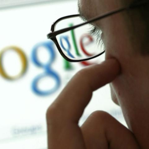 Man in front of a display with the website of the internet search engine Google, Germany. (Ulrich Baumgarten via Getty Images)