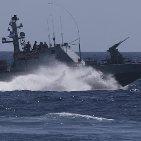 An Israeli Navy vessel passes by the Tamar drilling natural gas production platform during a squadron exercise on May 27, 2013 off the coast of Israel in the Mediterranean Sea. (Uriel Sinai/Getty Images)