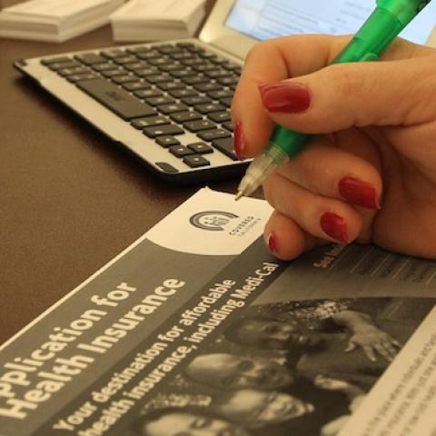 A healthcare reform specialist helps people select insurance plans at the free Affordable Care Act (ACA) Enrollment Fair at Pasadena City College on November 19, 2013 in Pasadena, California. (David McNew/Getty Images)