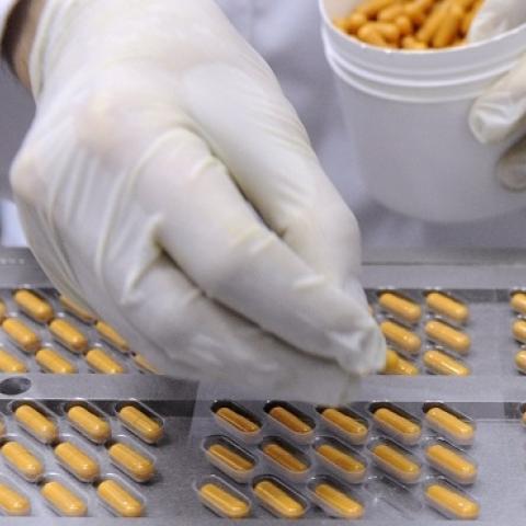 An employee fills blister packs with capsules at the end of the production chain at the Juva Sante Laboratoires plant, on March 13, 2013 in Forbach, France. (JEAN-CHRISTOPHE VERHAEGEN/AFP/Getty Images)