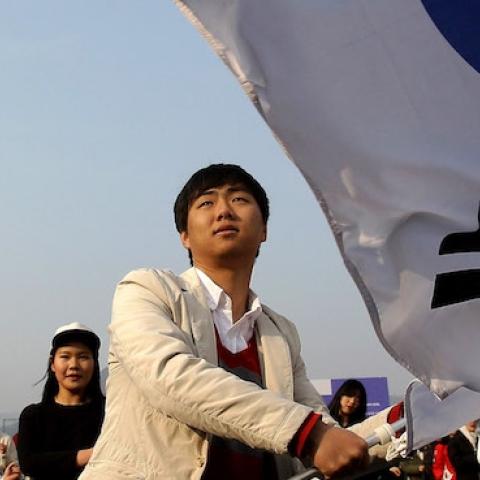 A South Korean student waves national flags during a rally on February 22, 2014 in Seoul, South Korea. (Chung Sung-Jun/Getty Images)