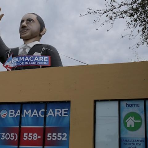 A sign waves from the top of insurance co. roof advertising for the Affordable Care Act, also known as Obamacare, as the company tries to sign people up before the February 15th deadline on February 5, 2015 in Miami, Florida. Numbers released by the gover