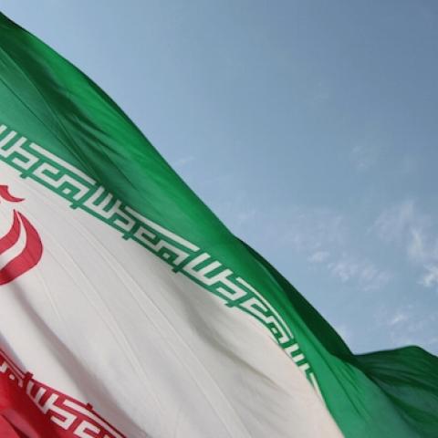 A flag flying at an undisclosed location in Iran next to a surface-to-surface Qiam-1 (Rising) missile, August 20, 2010. (VAHID REZA ALAEI/AFP/Getty Images)