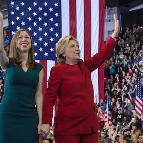 Democratic presidential nominee Hillary Clinton and Chelsea Clinton wave after a midnight rally at Reynolds Coliseum November 8, 2016 in Morrisville, North Carolina. (BRENDAN SMIALOWSKI/AFP/Getty Images)