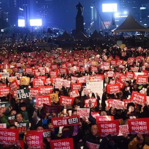 Protesters hold candles and banners calling for the resignation of South Korea's President Park Geun-Hye during an anti-government rally in central Seoul on November 19, 2016. (JUNG YEON-JE/AFP/Getty Images)