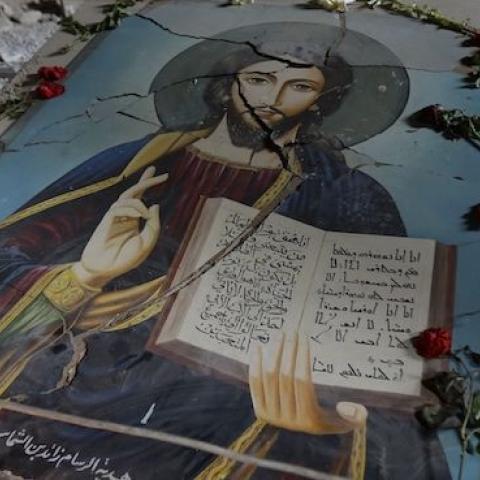 A damaged painting of Jesus Christ on the ground of Syriac Orthodox Um al-Zinar church in the Christian Hamidiyeh neighbourhood of the old city of Homs, central Syria, May 12, 2014. (JOSEPH EID/AFP/Getty Images)