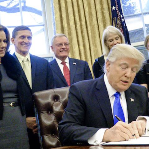 President Donald Trump signs three executive actions in the Oval Office on January 28, 2017 in Washington, DC. (Pete Marovich - Pool/Getty Images)