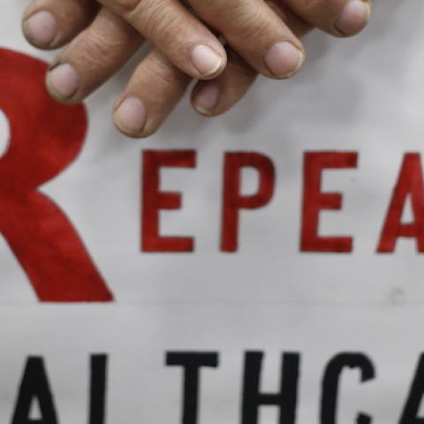 James Hughes of Louisville, Ky. holds a sign calling for the repeal of the Affordable Care Act during a rally for Mitch McConnell (R-KY) at Brandeis Machinery & Supply Company in Louisville, Kentucky, October 31, 2014. (Luke Sharrett/Getty Images)