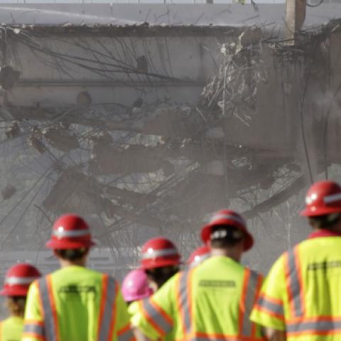 A group of people monitor construction crews demolishing a portion of the Mulholland Drive bridge along the 405 Freeway September 29, 2012 in Los Angeles, California. (Jonathan Alcorn/Getty Images)