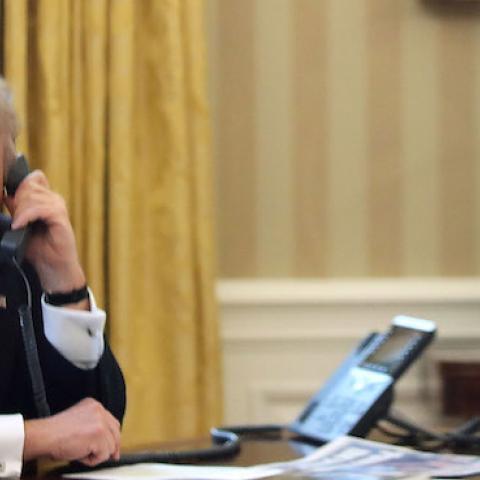 President Donald Trump is seen through a window speaking on the phone in the Oval Office of the White House, January 29, 2017 in Washington, DC. (Mark Wilson/Getty Images)