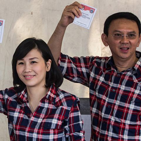 Basuki Tjahaja Purnama and his family show their ballot after voting in the Jakarta Governal Election on February 15, 2017 (Oscar Siagian/Getty Images)