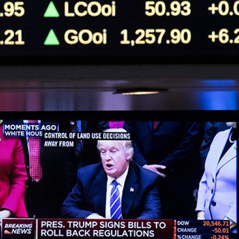 A television monitor shows President Donald Trump on the floor of the New York Stock Exchange, March 27, 2017 (Drew Angerer/Getty Images)