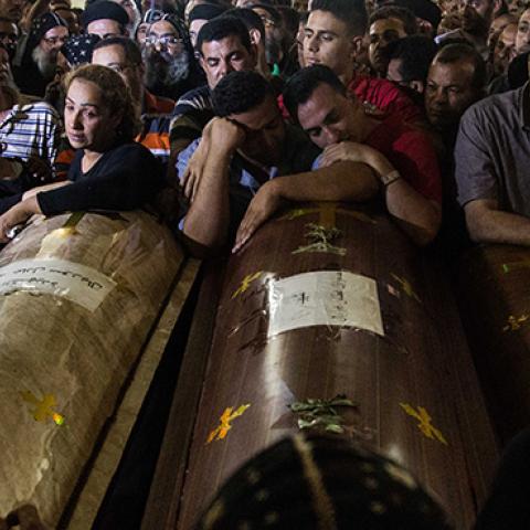 Relatives of Coptic Christians who were killed during a bus attack, surround their coffins, during their funeral service, at Ava Samuel desert monastery in Minya, Egypt, May 26, 2017 (Ibrahim Ezzat/NurPhoto via Getty Images)