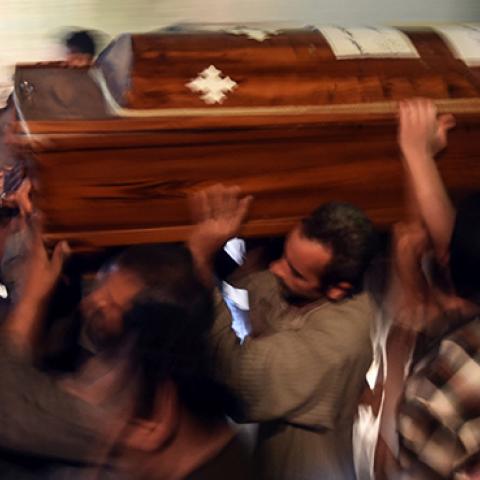 Relatives of killed Coptic Christians carry a coffin as they gather outside the Abu Garnous Cathedral in the north Minya town of Maghagha, on May 26, 2017 (MOHAMED EL-SHAHED/AFP/Getty Images)