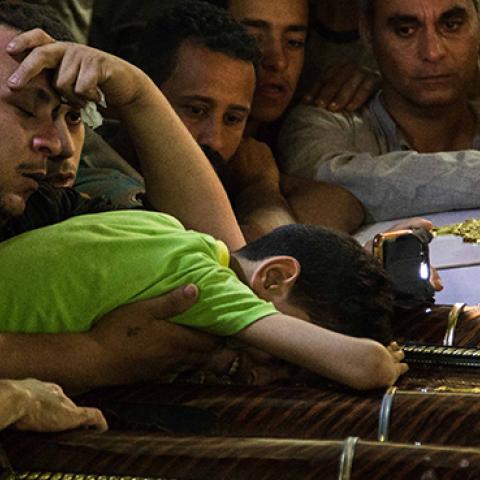 Child cries besides the coffins of his parents, who were killed in the Minya Bus Attack on May 26, 2017 (Ibrahim Ezzat/NurPhoto via Getty Images)